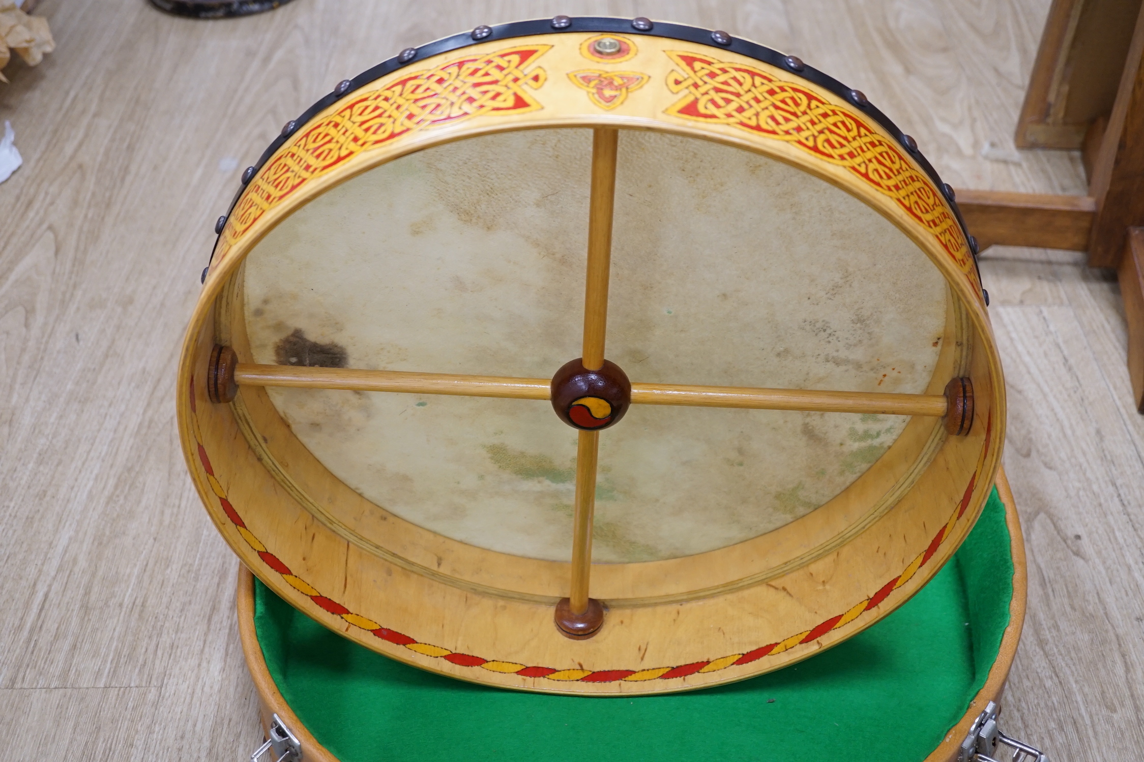 An Irish Bodhran drum with Celtic decorated plywood frame and goat skin, diameter 46cm, in fitted hard case, with beater